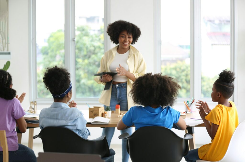 African American kids study with friends in class.